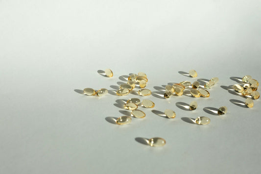 Scattered gold vitamin tablets